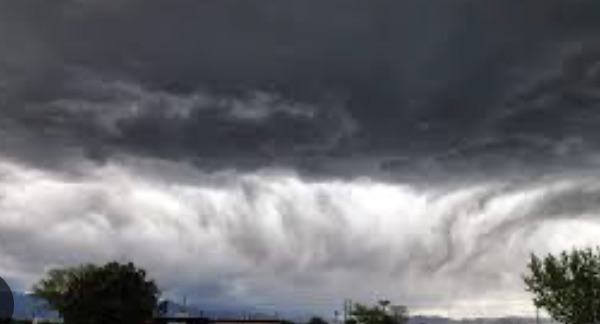 Severe storm cell rolling over a Colorado Springs neighborhood with the Front Range foothills behind — the hail corridor Revival Roofing services